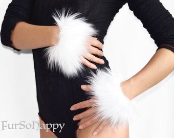 May include: A pair of white faux fur wrist cuffs worn on the wrists. The cuffs feature long, dense white synthetic fibers that create a voluminous, circular appearance around each wrist. The text FurSoHappy is visible in the bottom left corner.
