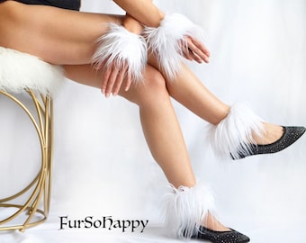 May include: White fluffy leg warmers with a black and white sparkly flat shoe. The leg warmers are made of faux fur and are worn on the lower legs. The shoes have a pointed toe and a low heel. The image is taken from the side and shows the leg warmers and shoes in detail. The text "FurSoHappy" is visible in the lower left corner of the image.