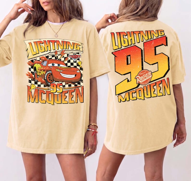 May include: A pale yellow t-shirt with a graphic of Lightning McQueen from the Cars film. The front design includes the text "Lightning 95 McQueen" with a cartoon image of the car. The back of the shirt has a large "95" and "Lightning McQueen" text.