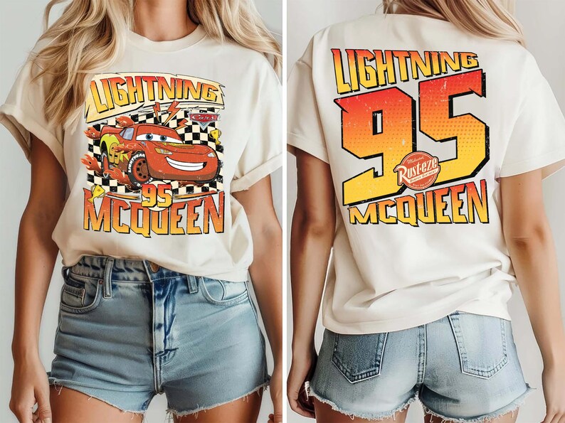 May include: Cream-coloured t-shirt featuring a graphic of Lightning McQueen from the Cars film. The front displays the character with the text "Lightning 95 McQueen." The back of the shirt has "Lightning 95 McQueen" in a gradient orange and yellow design.