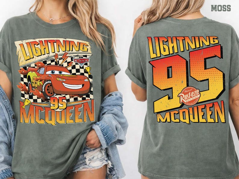May include: Moss green t-shirt featuring Lightning McQueen from the Cars movie. The front graphic shows McQueen with the text "LIGHTNING 95 MCQUEEN". The back of the shirt displays "LIGHTNING 95 MCQUEEN" in a large, bold design.