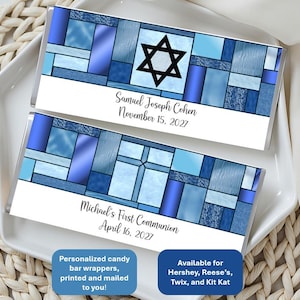 May include: Two candy bar wrappers with a stained glass design in shades of blue. One wrapper features a black Star of David and the text "Samuel Joseph Cohen November 15, 2027." The other wrapper has a cross and the text "Michael's First Communion April 16, 2027."