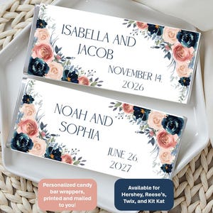 May include: Two candy bar wrappers with floral designs and names and dates. The top wrapper reads "ISABELLA AND JACOB NOVEMBER 14, 2026." The bottom wrapper reads "NOAH AND SOPHIA JUNE 26, 2027." The wrappers have a white background with navy, blush, and peach floral accents.