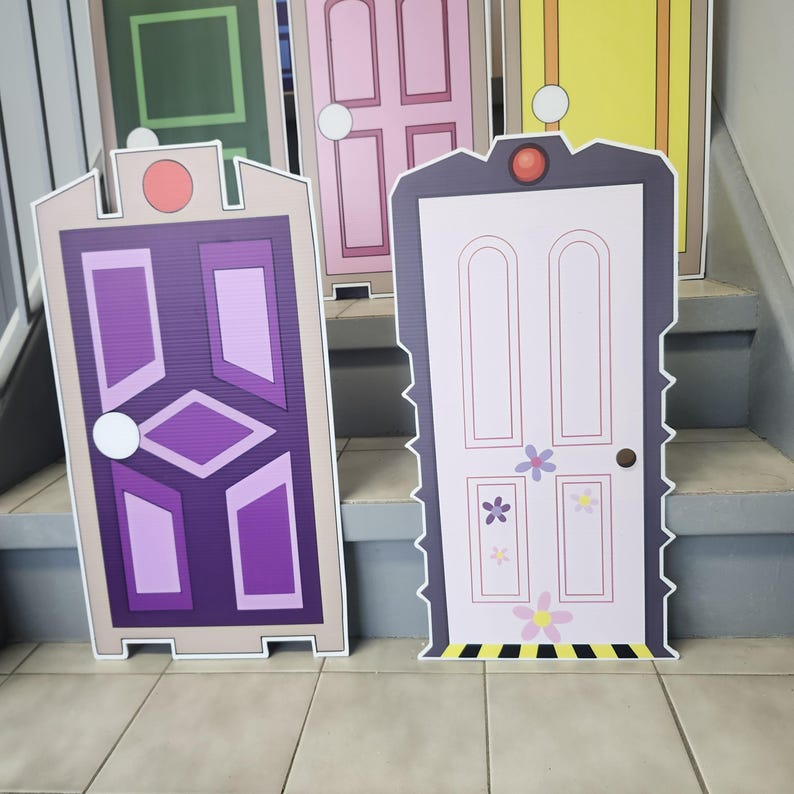 May include: Cardboard cutouts of colorful cartoon doors. The doors are various colors, including purple, pink, green, and yellow. The doors have unique designs and are arranged on a staircase. The doors are likely themed for a children's party or event.