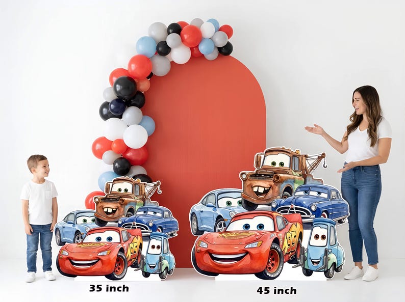 May include: Cardboard cutouts of Cars movie characters, including Lightning McQueen, Mater, and others, in various sizes. A red arch with a balloon garland and two people are also in the image. The larger cutout is 45 inches tall, and the smaller is 35 inches.