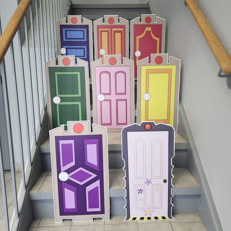 May include: A collection of colorful, cartoon-style door cutouts, each with unique designs and colors, including blue, orange, red, green, pink, and yellow. The doors are arranged on a staircase, suggesting a decorative or themed display.