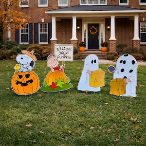Könnte beinhalten: Ein Set aus vier Rasendekorationen mit Peanuts-Figuren. Eine zeigt Snoopy und Woodstock in einem Kürbis, eine weitere Linus mit einem Schild mit der Aufschrift WELCOME GREAT PUMPKIN und zwei zeigen Kinder in weißen Geisterkostümen.