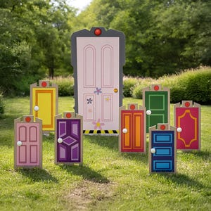 May include: A collection of colorful, cartoon-style door cutouts, including pink, yellow, purple, orange, green, and blue, are arranged on a grassy lawn. Each door has unique details and a red light on top, with a larger pink door in the background.