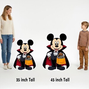 May include: Two Mickey Mouse vampire cutouts dressed in black capes with red linings, white ruffled shirts, and black vests, each holding an orange candy bucket. The left cutout is labeled 35 inch Tall and the right is 45 inch Tall.