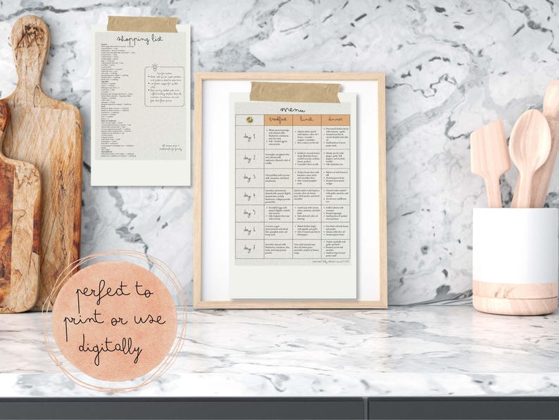 May include: A framed menu and shopping list are displayed on a marble countertop. The menu is divided into columns for breakfast, lunch, and dinner. The shopping list is taped to the wall with the text "shopping list". A decorative circle with the text "perfect to print or use digitally" is in the foreground.