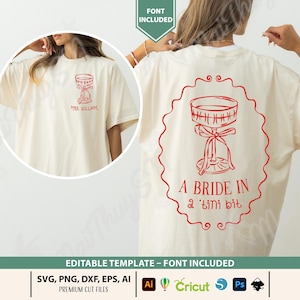 May include: Cream-colored t-shirt with a red graphic of a cocktail glass and the text "A Bride in a 'tini bit". The front of the shirt has the text "Mrs. William" and a similar cocktail glass design. The shirt is a wedding-themed item.