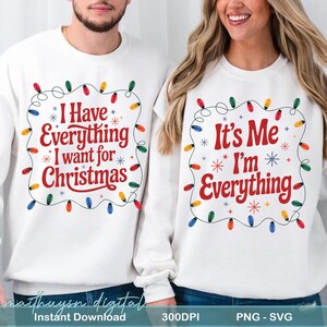 May include: White sweatshirts with Christmas-themed text. One says "I Have Everything I want for Christmas" and the other says "It's Me I'm Everything". Both designs feature colorful Christmas lights and snowflakes.
