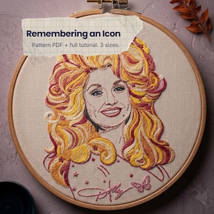 May include: An embroidery hoop containing a portrait of a person with voluminous wavy hair in shades of yellow, orange, and pink. The text "Remembering an Icon" and "Pattern PDF + full tutorial. 3 sizes." is printed on a paper overlay on the hoop.