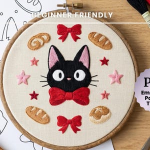 May include: Embroidery hoop featuring a black cat with a red bow tie, surrounded by embroidered stars and bread shapes. The text "BEGINNER FRIENDLY" and "PDF Embroidery Pattern & Tutorial" are also visible.