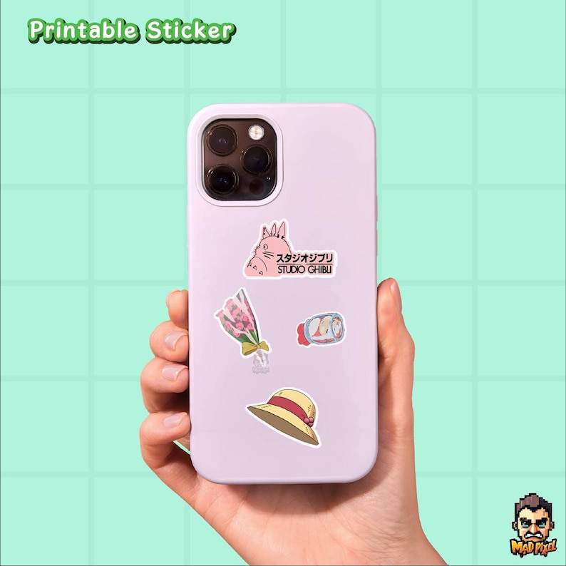 May include: A light purple phone case with several stickers applied. The stickers include a pink cartoon rabbit, a bouquet of flowers, a roll of food, and a straw hat. The text "Printable Sticker" is at the top.