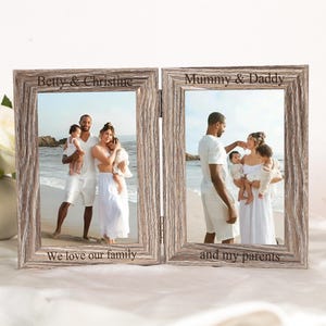 May include: A double-hinged, rustic-style wooden picture frame. Each frame displays a family photo. The left frame reads "Betty & Christine, We love our family." The right frame reads "Mummy & Daddy and my parents."