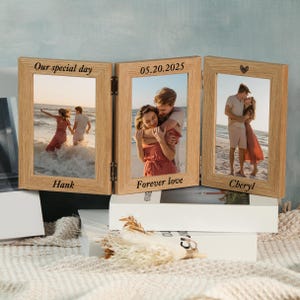 May include: A wooden triple photo frame with three pictures of a couple on a beach. The frame is engraved with the words "Our special day", "05.20.2025", "Forever love", "Hank", and "Cheryl". A heart is engraved on the right frame.