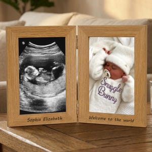 May include: A wooden, hinged picture frame displaying a sonogram image and a photo of a newborn baby. The sonogram is labeled "Sophia Elizabeth." The baby photo is labeled "Snuggle Bunny" and "Welcome to the world."