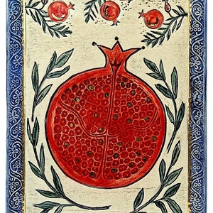 May include: A hand-painted wooden plaque with a blue and gold border. The plaque features a red pomegranate with green leaves and a white background.