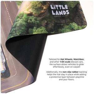 May include: A flexible play mat featuring a printed landscape with roads and green terrain, branded Little Lands. The mat has a black, textured non-slip rubber backing and is designed for 1:64 scale diecast cars. The surface shows a road layout.