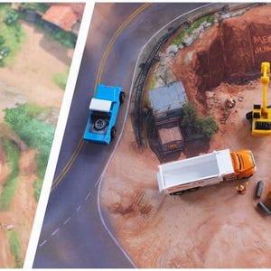 May include: A split-view play mat featuring a natural landscape with a blue river, green trees, and yellow and white toy vehicles on the left, and a construction site with yellow excavators, a dump truck, and a blue truck on the right side.