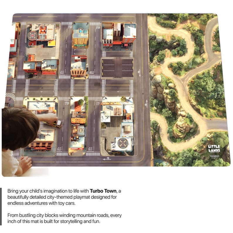 May include: A rectangular playmat featuring a detailed city grid with buildings, roads, and intersections on the left side, transitioning into a winding mountain road landscape on the right side, with the text Little Lands printed in the corner.