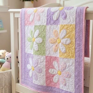 May include: A pastel-colored baby quilt with large flower designs. The quilt features squares of pink, green, yellow, and purple, each with a white flower. The quilt is draped over a white crib.