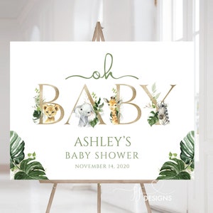 K&ouml;nnte beinhalten: Ein wei&szlig;es Schild mit goldenen Buchstaben, auf dem "oh baby" steht, mit einem gr&uuml;nen Blattdesign und Tierillustrationen. Das Schild enth&auml;lt auch den Text "Ashley's Baby Shower" und "November 14, 2020".