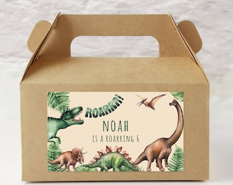 May include: A brown cardboard box with a handle. The box has a sticker on the front with a dinosaur theme. The sticker has a green and brown dinosaur, a green pterodactyl, and a brown brachiosaurus. The sticker also has the text "ROARRR! NOAH IS A ROARRING 6".