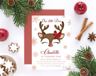 May include: A white invitation card with a red and brown reindeer illustration. The text on the card reads "Our little Deer Charlotte is turning one. Join us for some reindeer fun Saturday, December 07, 2019 at 2:00pm-7:00pm 777 Amber Lakes Road Orlando Florida RSVP to Amy at 1407-909-9898"