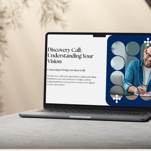 May include: A laptop displaying a presentation titled "Discovery Call: Understanding Your Vision." The screen shows text and an image of a man smiling and writing. The laptop is open on a light gray surface.