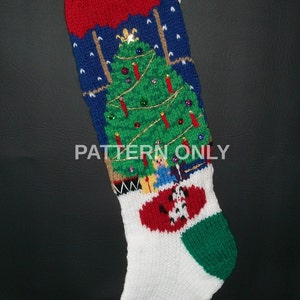 May include: A knitted Christmas stocking with a blue background, a red and white candy cane stripe, and a green, white, and red Christmas tree with ornaments and lights. The stocking has a white cuff and a green and red heel.