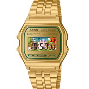 May include: Gold-tone Casio digital watch with a rectangular face and matching band. The watch face displays a colorful graphic and the time. The watch has the text "CASIO" and "WATER RESIST" printed on the face.