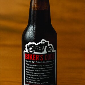 May include: A dark brown beer bottle with a label that reads "BIKER'S CODE" and features a motorcycle graphic. The label also includes text in a smaller font. The bottle is on a wooden surface.