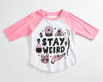 Stay Weird Solid White/Pink Raglan Kids T-Shirt. 3/4 length baseball child tee. Spooky, magic shirt for Boys and Girls