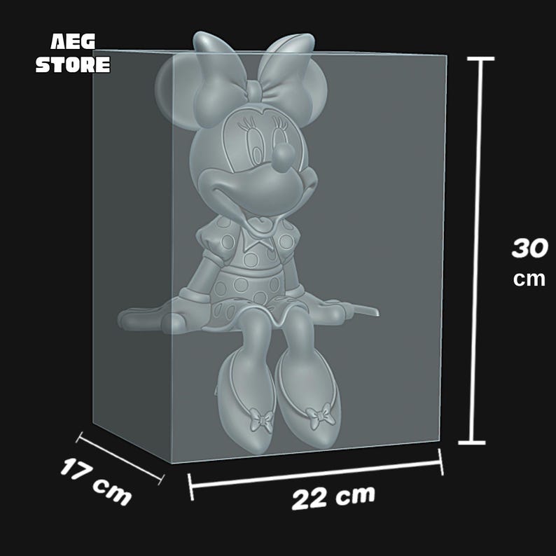 May include: A gray Minnie Mouse figure, 30 cm tall, inside a clear rectangular display case. The case measures 22 cm wide and 17 cm deep. The figure is wearing a dress with polka dots and a large bow. The text "AEG STORE" is in the upper left corner.