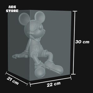 May include: A gray Mickey Mouse figurine, seated, inside a clear display case. The case measures 22 cm wide, 21 cm deep, and 30 cm high (approximately 8.7 x 8.3 x 11.8 inches). The "AEG STORE" logo is visible in the upper left corner.