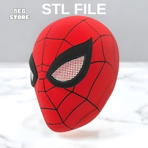 May include: A red and black Spider-Man mask with white mesh eye coverings. The mask has a webbed design and is labeled "STL FILE" with the "AEG STORE" logo in the upper left corner.
