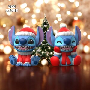 May include: Two blue cartoon character figurines, each wearing a red Santa hat and outfit, with a white trim. One figurine is smiling, and the other is winking. A small Christmas tree is in the background. The text "AEG STORE" is in the top left corner.