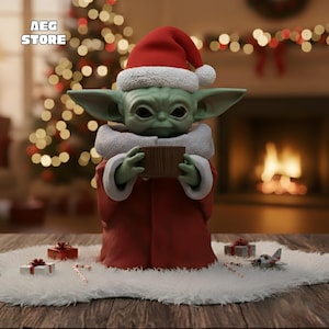 May include: A green creature figurine with large ears and dark eyes, wearing a red Santa hat with white trim and a matching red robe with a white collar. The figure holds a small brown rectangular object. Text AEG STORE appears in the corner.