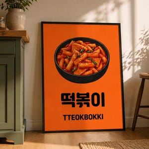 Può includere: Un poster incorniciato con sfondo arancione presenta una ciotola di tteokbokki, un piatto di street food coreano. Il piatto è in una ciotola nera e il poster ha il testo coreano e inglese "TTEOKBOKKI". Il poster è in una cornice nera.