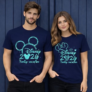 May include: Navy blue t-shirts with a Disney 2020 Family Vacation design. One shirt features a Mickey Mouse head outline, the other a Minnie Mouse bow. Both shirts have a glittery, turquoise design.