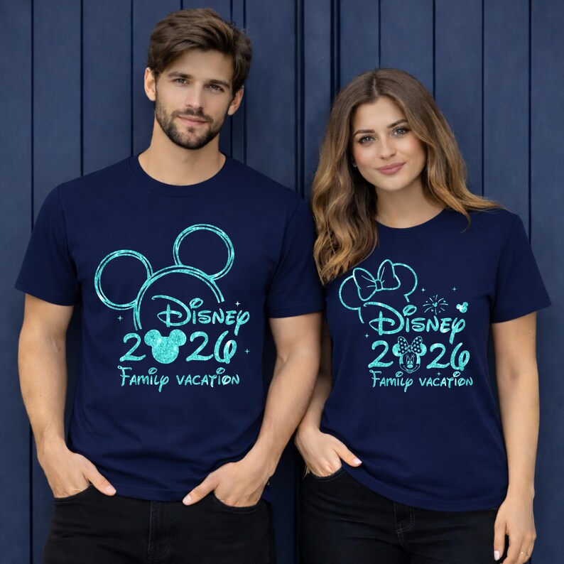 May include: Navy blue t-shirts with a Disney 2020 Family Vacation design. One shirt features a Mickey Mouse head outline, the other a Minnie Mouse bow. Both shirts have a glittery, turquoise design.