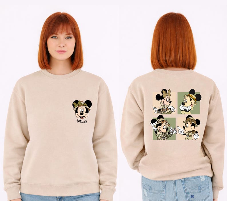 May include: Beige sweatshirt with Minnie Mouse in safari gear on the front and back. The front shows Minnie's face, while the back has four images of Minnie and Mickey Mouse in safari outfits, set against a green backdrop.