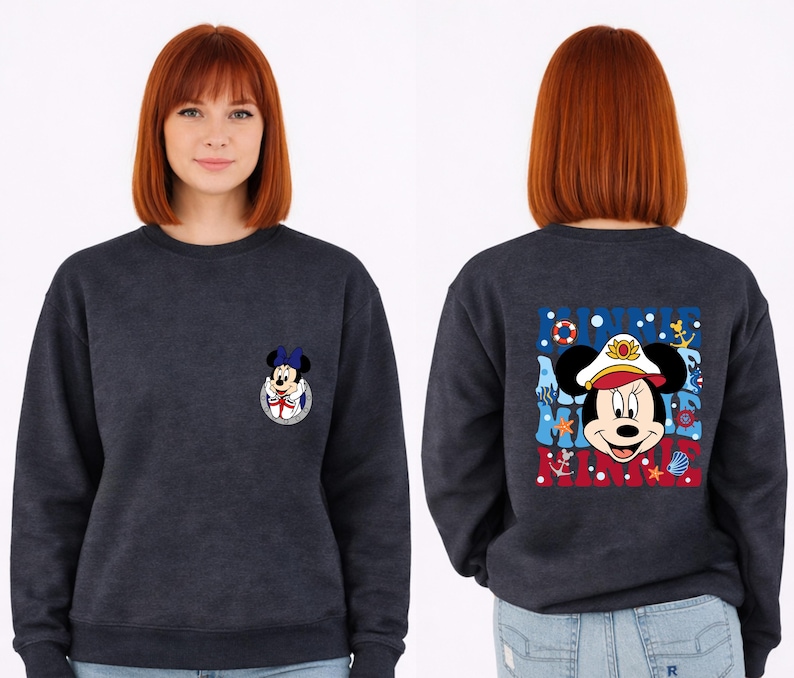 May include: Navy blue sweatshirt featuring Minnie Mouse in a sailor outfit. The front has a small Minnie Mouse graphic, while the back displays a larger design with the words "Minnie Mouse" and nautical elements like anchors and seashells.