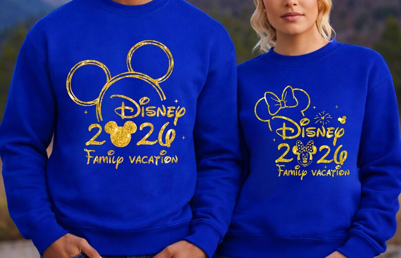 May include: Two blue sweatshirts with gold glitter designs. One features Mickey Mouse ears and the text "Disney 2020 Family Vacation." The other has Minnie Mouse ears and the same text. A fun matching set for a family vacation.