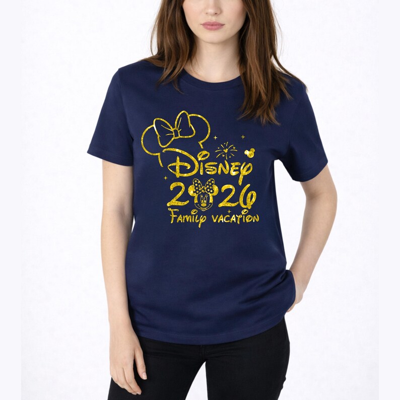 May include: Navy blue t-shirt with a gold glitter design. The design includes a bow, the word "Disney", the numbers "2026", a Minnie Mouse head, and the words "Family Vacation". The shirt is a crew neck style.