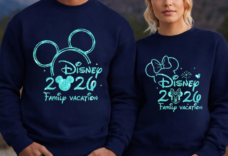 May include: Navy blue sweatshirts with a turquoise Disney design. One features Mickey Mouse ears, the other Minnie Mouse ears. Both say "Disney 2020 Family Vacation."