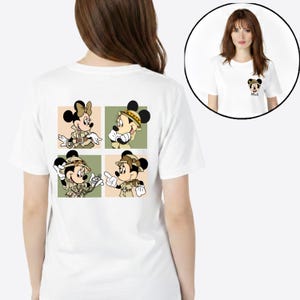May include: White t-shirt with a small Minnie Mouse graphic on the front and a four-panel design on the back. The back design shows Minnie and Mickey Mouse in safari outfits. The shirt is made of a soft, comfortable material.