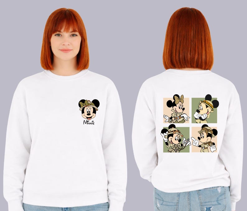 May include: White sweatshirt with Minnie Mouse design. The front has a small Minnie Mouse graphic with a bow and the word "Minnie". The back features four square images of Minnie Mouse in safari outfits. A comfortable, casual top.